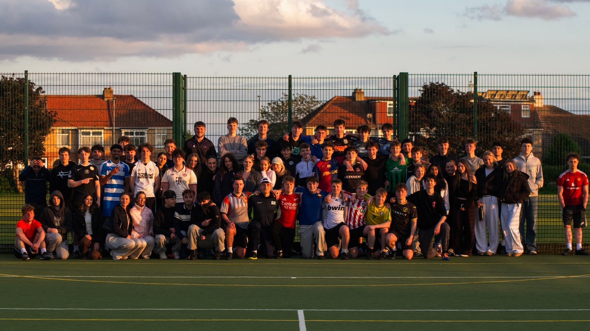 Five-a-side society members together for a group photograph on the pitch